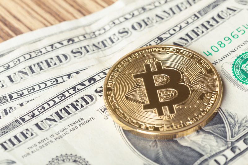 golden-bitcoin-coin-and-one-dollar-banknote-2022-06-27-15-47-05-utc.jpg